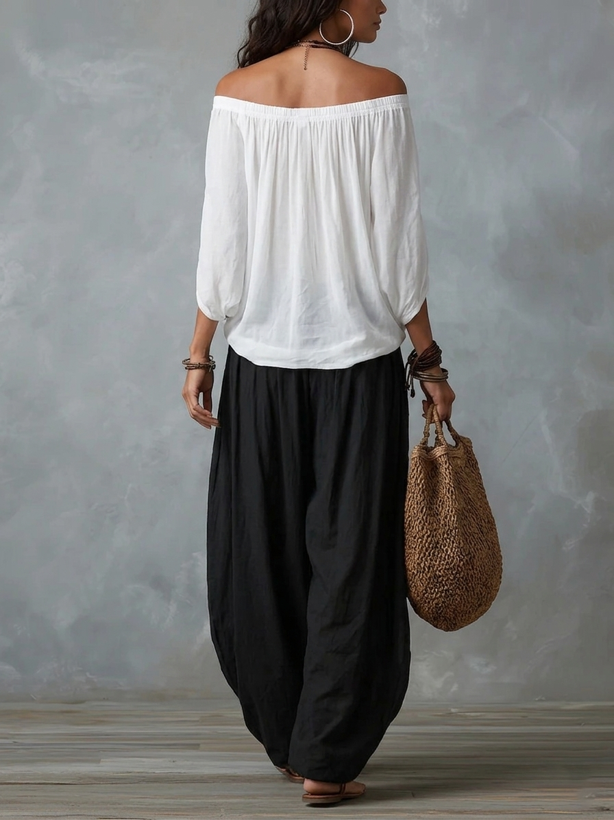 Top blanco con hombros al aire y conjunto de pantalones anchos tipo linterna