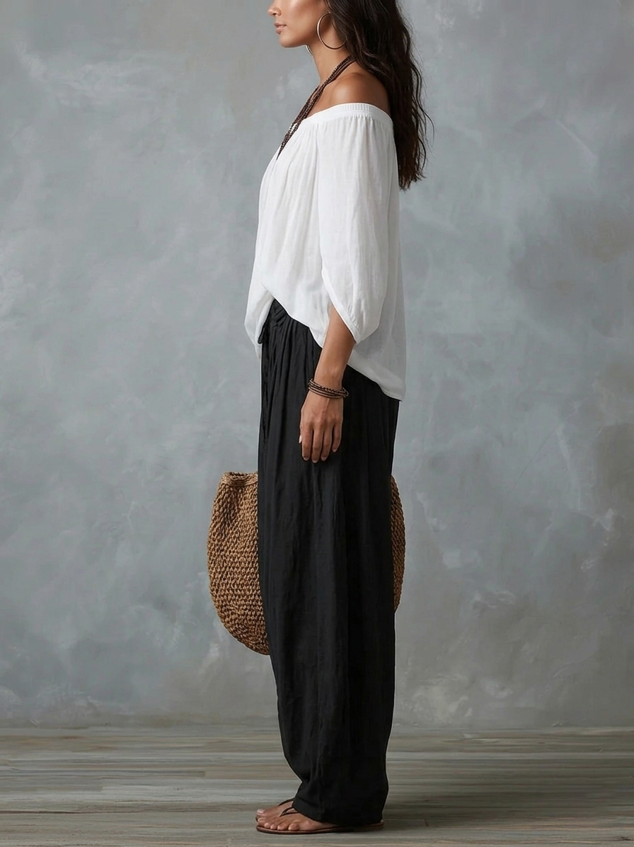 Top blanco con hombros al aire y conjunto de pantalones anchos tipo linterna