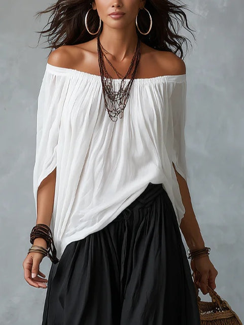 Top blanco con hombros al aire y conjunto de pantalones anchos tipo linterna