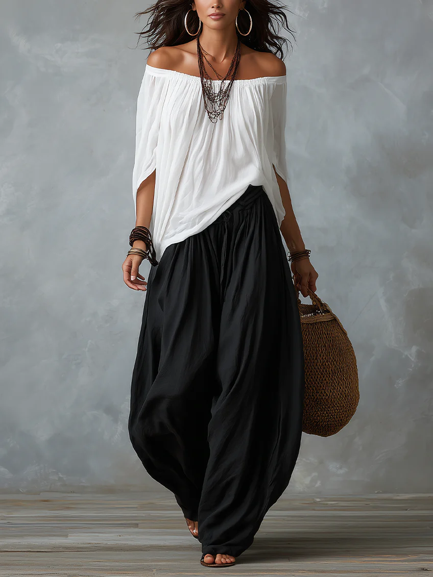 Top blanco con hombros al aire y conjunto de pantalones anchos tipo linterna